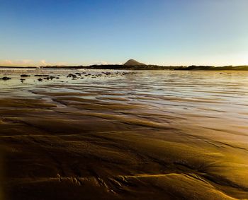 Scenic view of beach against clear sky