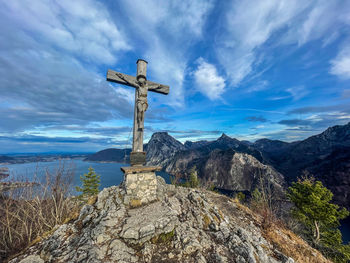 Cross on mountain against sky