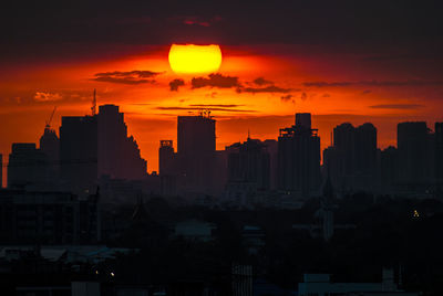 Silhouette buildings against sky during sunset