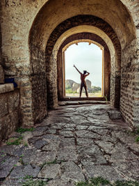 Rear view of man standing in tunnel