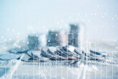 Digital composite image of cityscape and bridge against sky