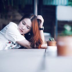 Young woman sitting at table