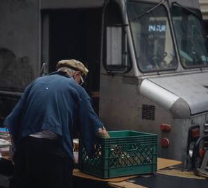 Rear view of woman working at bus