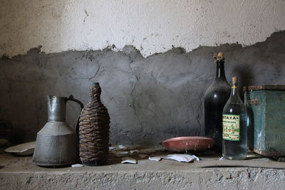 Close-up of abandoned bottles on table