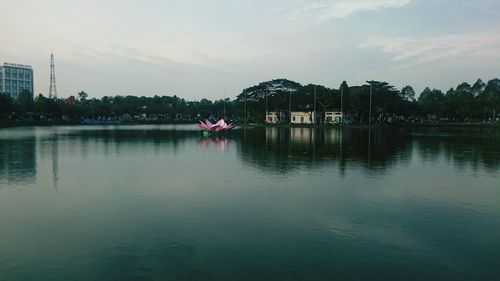 Reflection of built structure in water against sky