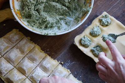 High angle view of person preparing food on table