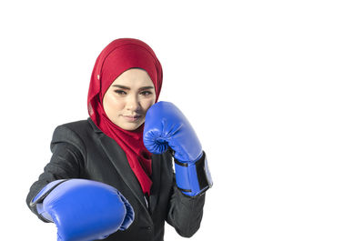 Portrait of smiling young woman against white background