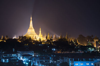 Illuminated cathedral against sky at night