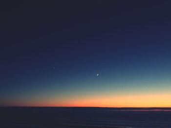 Scenic view of sea against clear sky at night