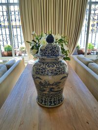 Flower vase on table at home