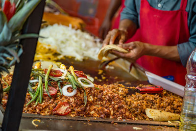 Man preparing food at market stall