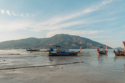 Boats in sea against sky