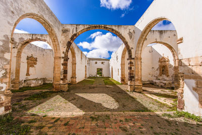 Archway of historic building against sky