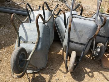 High angle view of old wheelbarrows on field