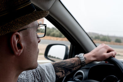 Close-up portrait of man in car