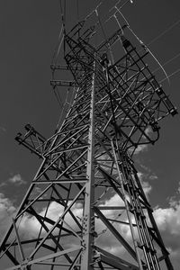 Low angle view of electricity pylon against sky