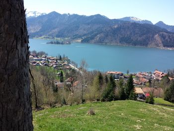 Scenic view of sea and buildings against mountains