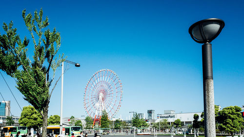 Low angle view of ferris wheel against sky