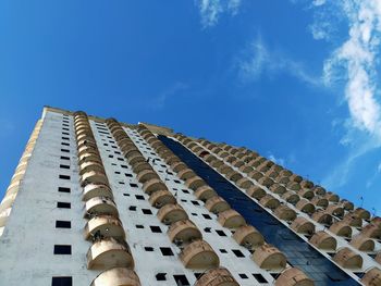 Low angle view of modern building against blue sky