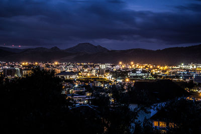 High angle view of illuminated buildings in city at night