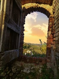 Stone wall of old building against sky