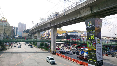 View of city street and bridge against clear sky