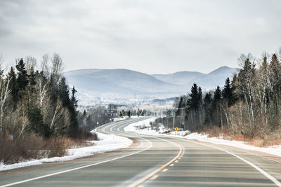 Winter road to the mountains, an empty winding highway in canada