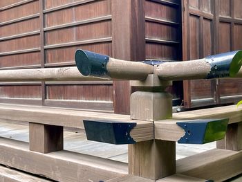 Low angle view of man standing by fence