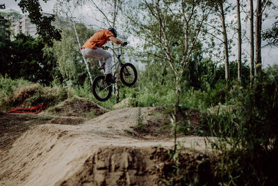 Man riding bicycle in forest