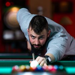 Young man playing snooker