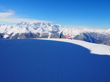 Tourists on snow covered mountain