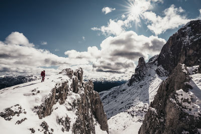Female alpinist overlooking scenic valley in the italian dolomites