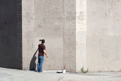 Full length rear view of man walking in building