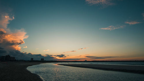 Scenic view of beach against sky during sunset