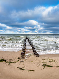 Lifeguard hut on beach against sky