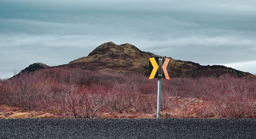 Yellow flag on road against mountain