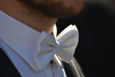 Midsection of man wearing tied bow