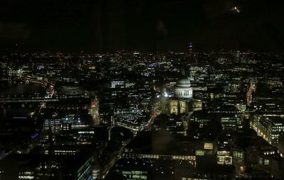 High angle view of illuminated buildings in city at night