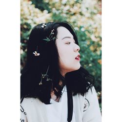 Close-up of young woman standing outdoors