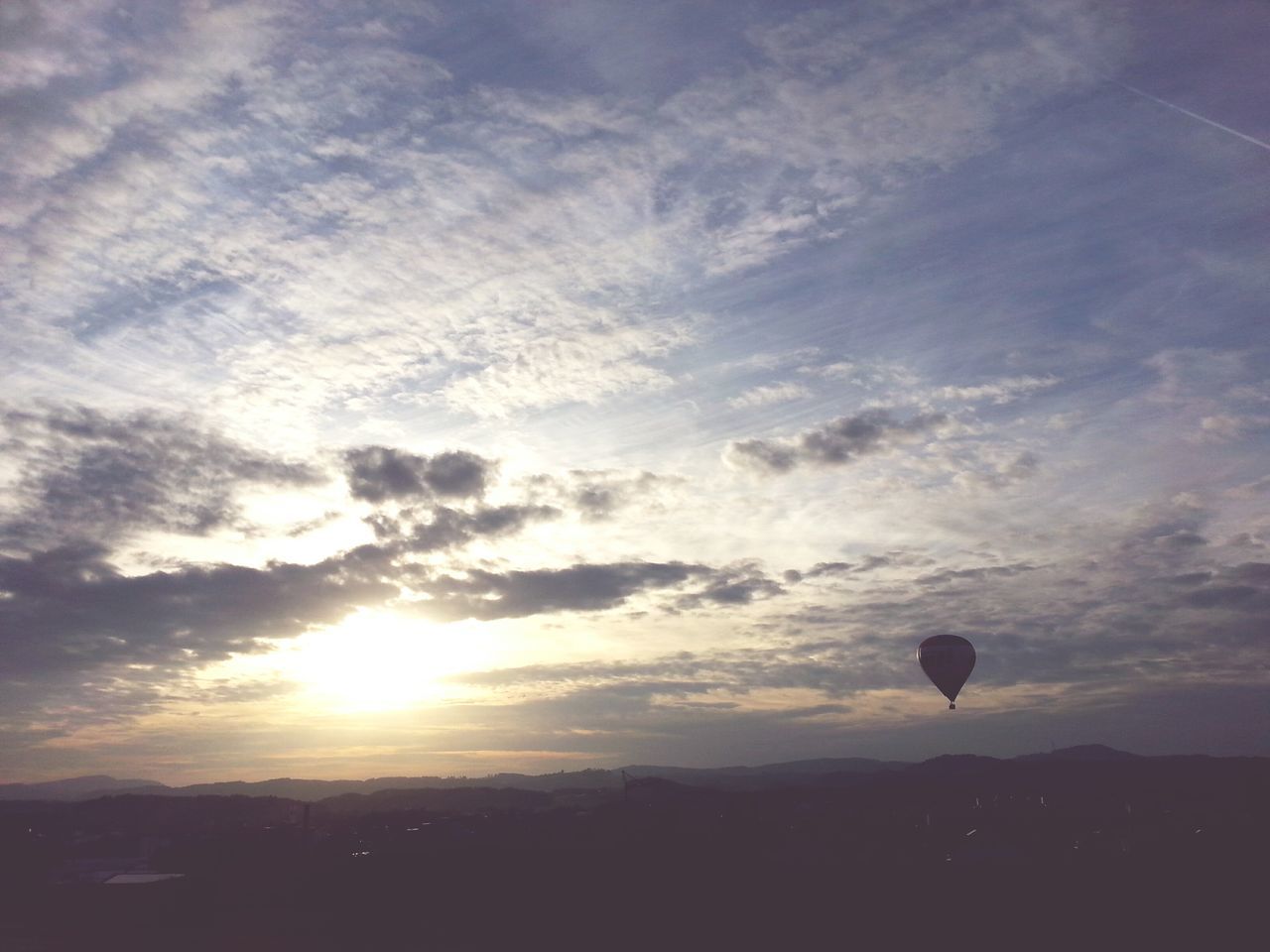 HOT AIR BALLOON FLYING AGAINST SKY