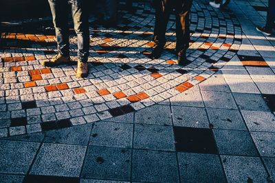 Low section of people walking on footpath