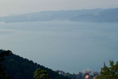 Scenic view of sea and mountains against sky