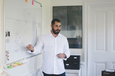 Mature businessman giving presentation in creative office