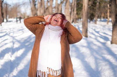Happy woman standing on snow
