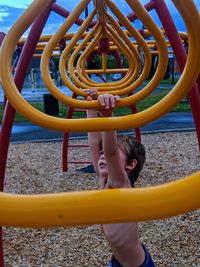 Shirtless boy playing in playground