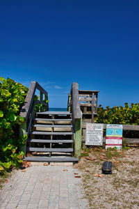 Built structure on footpath against clear blue sky