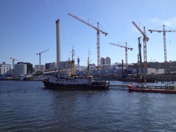 Commercial dock in sea against clear sky