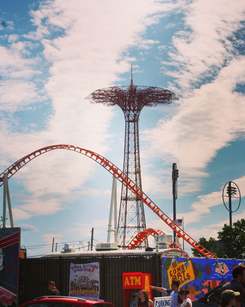 amusement park, arts culture and entertainment, amusement park ride, fairground ride, fairground, sky, leisure activity, low angle view, ride, ferris wheel, cloud - sky, outdoors, day, rollercoaster, big wheel, group of people, large group of people, men, carousel, people