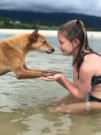 Girl with dog in lake