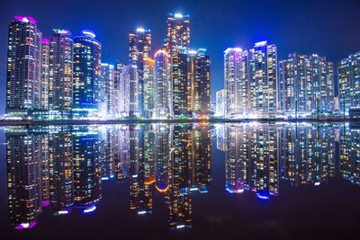 Illuminated modern buildings in city at night